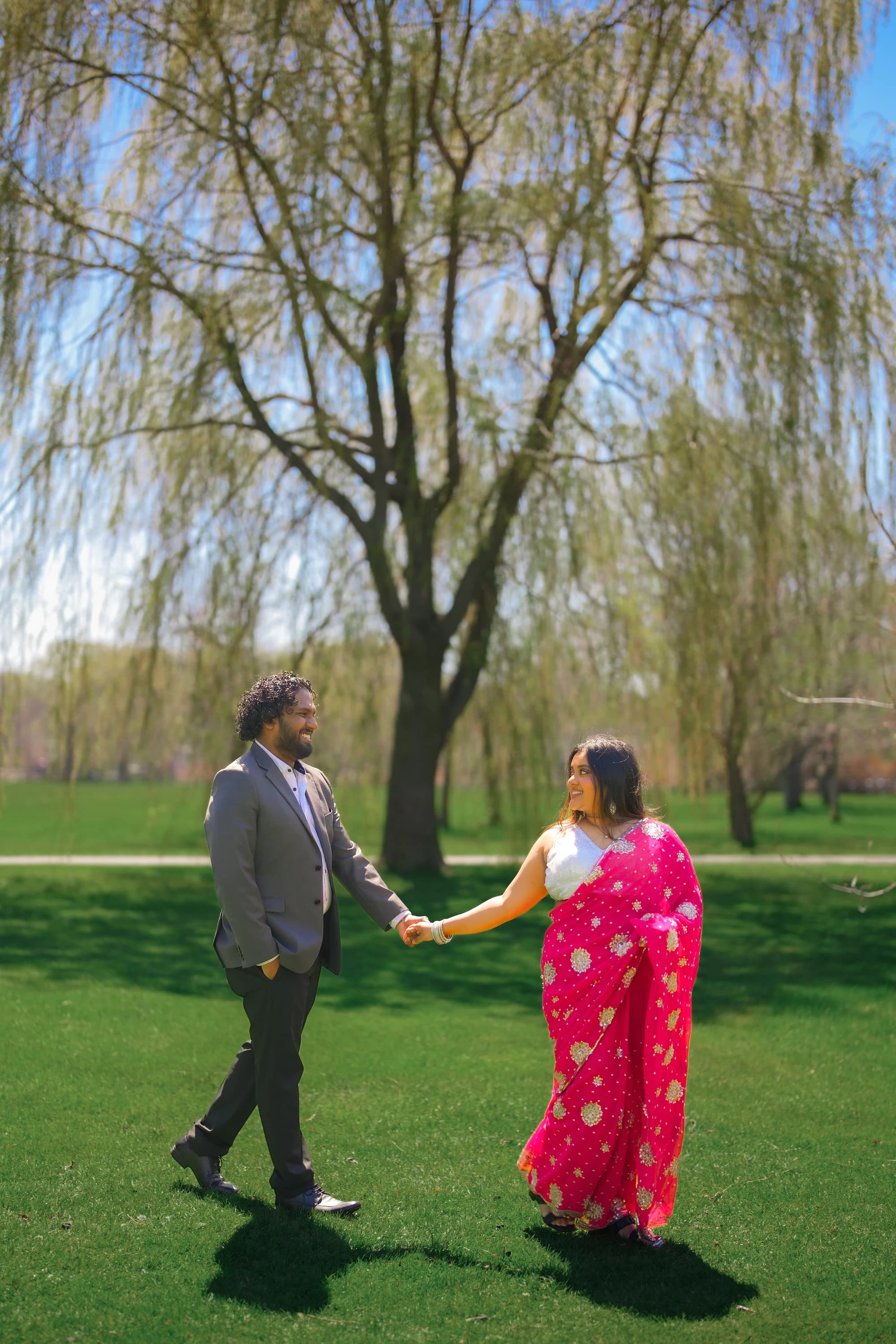 Arnab and Sudipra walking together by willow trees